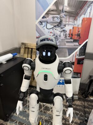A Humanoid robot wears a METAL ball cap.