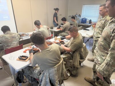 A group of soldiers prepares sand molds during a training source.