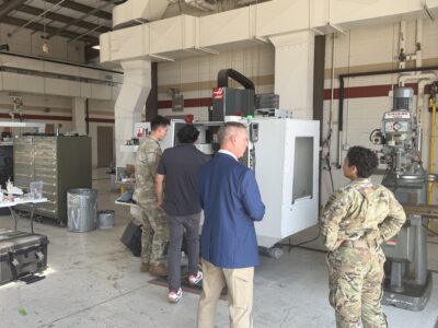 Andrew Pokelwaldt speaks with a soldier while observing the JAMS training session.